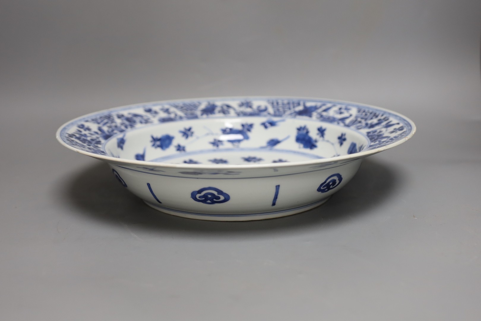 A Chinese blue and white ‘ladies’ basin, Kangxi period, cracked 34cm